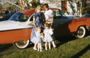 Slide of family standing by car, circa 1950s