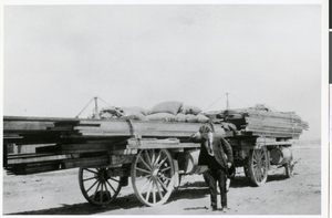 Photograph of Jake Beckley, partner with Ed Von Tobel, Sr., next to supply wagon, LAs Vegas, circa 1900s