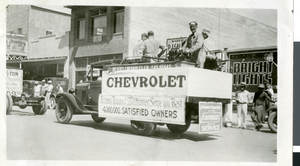 Photograph of Merle Frehner and co-workers riding on the Desert Chevrolet Company entry for the first Las Vegas Labor Day Parade, circa 1930s