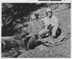 Photograph of an unidentified man with the animal he killed, circa 1930s