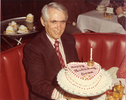 Photograph of Mayor Oran K. Gragson displaying his birthday cake, circa 1970s