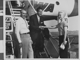 Photograph of Mayor Oran K. Gragson greeting Lawrence Welk as he deplanes after a TWA flight, circa 1960s
