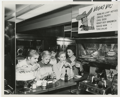 Photograph of Bluebell Girls eating at a Las Vegas restaurant or diner, 1958