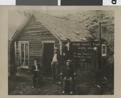 Postcard of three men outside of Mark Twain's cabin, Aurora, Nevada, circa 1870s-1880s