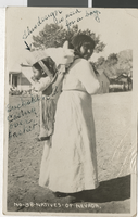 Photograph of a Native American woman carrying an infant in a cradleboard, probably in Nevada, circa 1910s