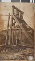 Photograph of a man standing on a mining headframe, Gold Reef Mining Company, Tonopah, Nevada, July 7, 1918