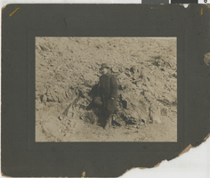 Photograph of Jim Butler standing by one of his first ore strikes in Tonopah, Nevada, circa 1900s