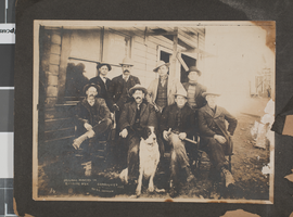 Photograph of eight men outside of the Rawhide Consolidated Mines Company office, Rawhide, Nevada, 1908