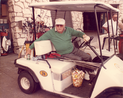Photograph of Jay Sarno in a golf cart, circa 1980