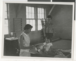 Photograph of unidentified mother and children in barracks, Boulder City, 1953