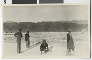 Photograph of Robert and Mary Lake and two men standing on a dirt road, 1910s