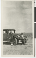 Photograph of Nellie Lake (Waite) and Claude Mackie standing by an automobile, 1928