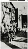 Photograph of two children and a baby standing outside a house, Las Vegas (Nev.), 1929