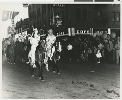 Photograph of Clarence Cleveland, Frances Kruzeman, and others in a parade, 1940s