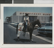 Photograph of a woman on a horseback with a sign advertising "Cat Ballou," Las Vegas (Nev.), mid 1960s