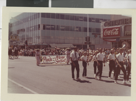 Photograph of several individuals dressed in Chinese clothing holding a sign at the Helldorado Parade, late 1950s
