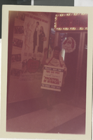 Photograph of a woman holding a sign advertising "Pocketful of Miracles" outside of the Fremont Theatre, Las Vegas (Nev.), 1961
