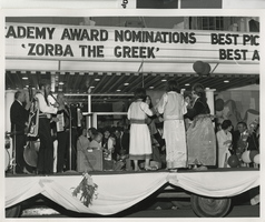 Photograph of performance in front of the Guild Theatre marquee advertising "Zorba the Greek," Las Vegas (Nev.), 1965