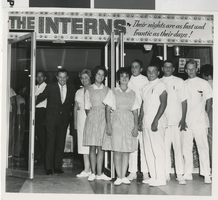 Photograph of several people in front of the Fremont Theatre in costume, Las Vegas (Nev.), 1962
