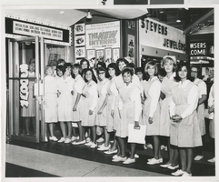 Photograph of nurses and candy stripers in front of the Fremont Theatre in costume, Las Vegas (Nev.), 1964