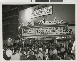 Photograph of a band entertaining a crowd outside of the Fremont Theatre, advertising "Rock Around the Clock" and "Overexposed,"  Las Vegas (Nev.), 1956