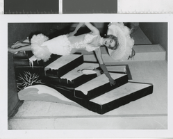 Photograph of showgirl in white dress, Las Vegas (Nev.), 1957-1960s