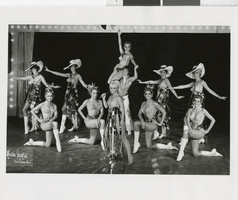 Photograph of eleven Minsky's Burlesque cast members on stage at the Aladdin, Las Vegas (Nev.), 1968-1973