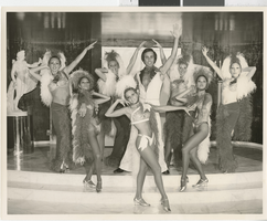 Photograph of eight Minsky's Burlesque cast members posing on stage at the Playboy Hotel, Chicago (Ill.), circa 1977