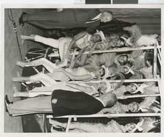 Photograph of Harold Minsky posing with nine showgirls, 1970-1979