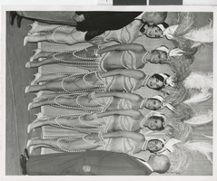 Photograph of Harold Minsky posing with six of his showgirls, 1970-1979