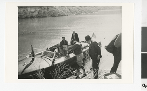 Photograph of men unloading a boat on the Colorado River, November 11, 1935