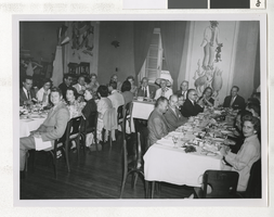 Photograph of business people eating with C. D. Baker, 1950-1960s