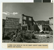 Photograph of a sign warning treasure hunters and looters, Rhyolite (Nev.), 1920-1950