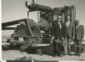 Photograph of people in suits near a construction machine, Las Vegas (Nev.), January 25, 1963