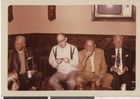 Photograph of men on a couch, 1970-1985