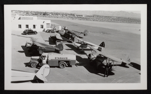 Photograph of fuel truck and propeller airplanes in the desert, Boulder City, Nevada, circa 1930s