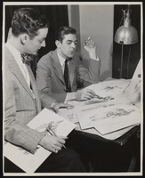 Photograph of Donn Arden reviewing costume designs, 1940s