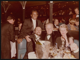 Photograph of Donn Arden, Margaret Kelly, and others at Lido dinner party, Paris (FRA), 1970s