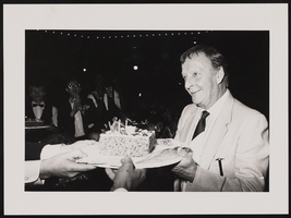 Photograph of Donn Arden accepting a birthday cake, 1970s