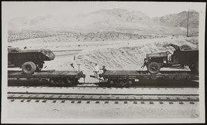Photograph of a train and two men, Boulder City (Nev.), approximately 1931-1936
