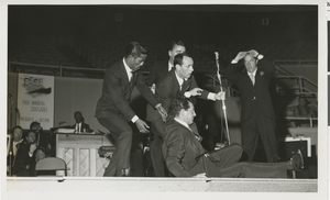 Photograph of Sammy Davis, Jr., Joey Bishop, Peter Lawford and Dean Martin onstage during a Four Immortal Chaplains benefit at the Las Vegas Convention Center, February 7, 1960