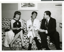 Photograph of Dean Martin meeting with reporters in his dressing room at the Sands Hotel, Las Vegas, December 1959.