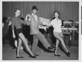 Photograph of Dean Martin dancing with two Texas Copa Girls, Las Vegas, December 1959