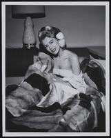 Woman with mink bedspread at the Sands Hotel: photographs