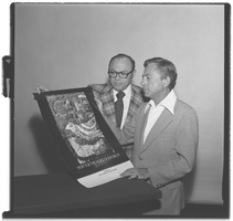 Photographs of Combined Jewish Appeal members holding a poster, July 05, 1977