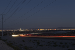 Headlights streak as cars drive on 215 the Beltway at night, Las Vegas, Nevada: digital photograph