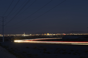 Headlights streak as cars drive on 215 the Beltway at night, Las Vegas, Nevada: digital photograph