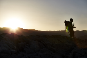 Hiker on Lone Mountain at sunset, Las Vegas, Nevada: digital photograph