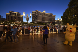 Tourists and a cartoon character in front of The Bellagio hotel and casino, Las Vegas, Nevada: digital photograph