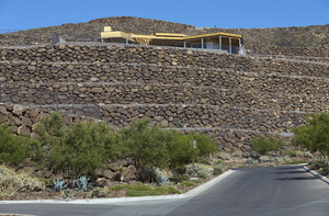 New home under construction with rock retaining walls at Ascaya develpment, Henderson, Nevada: digital photograph